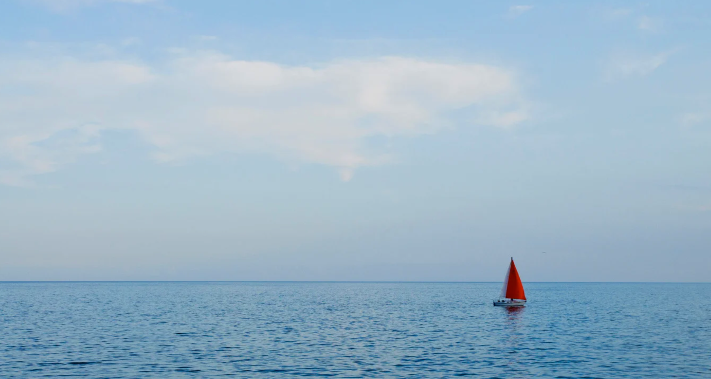 sailboat sailing on an empty sea