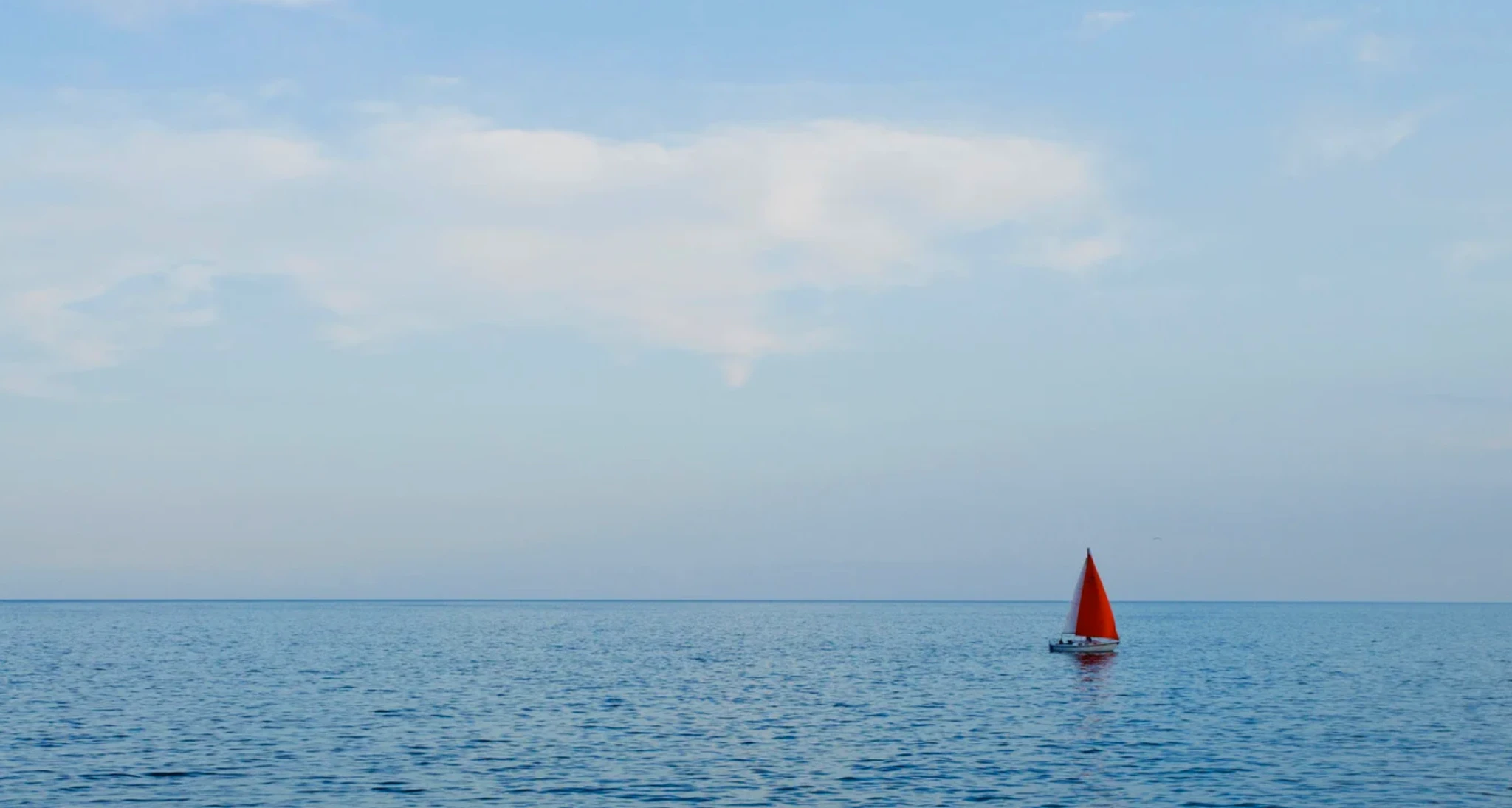 sailboat sailing on an empty sea